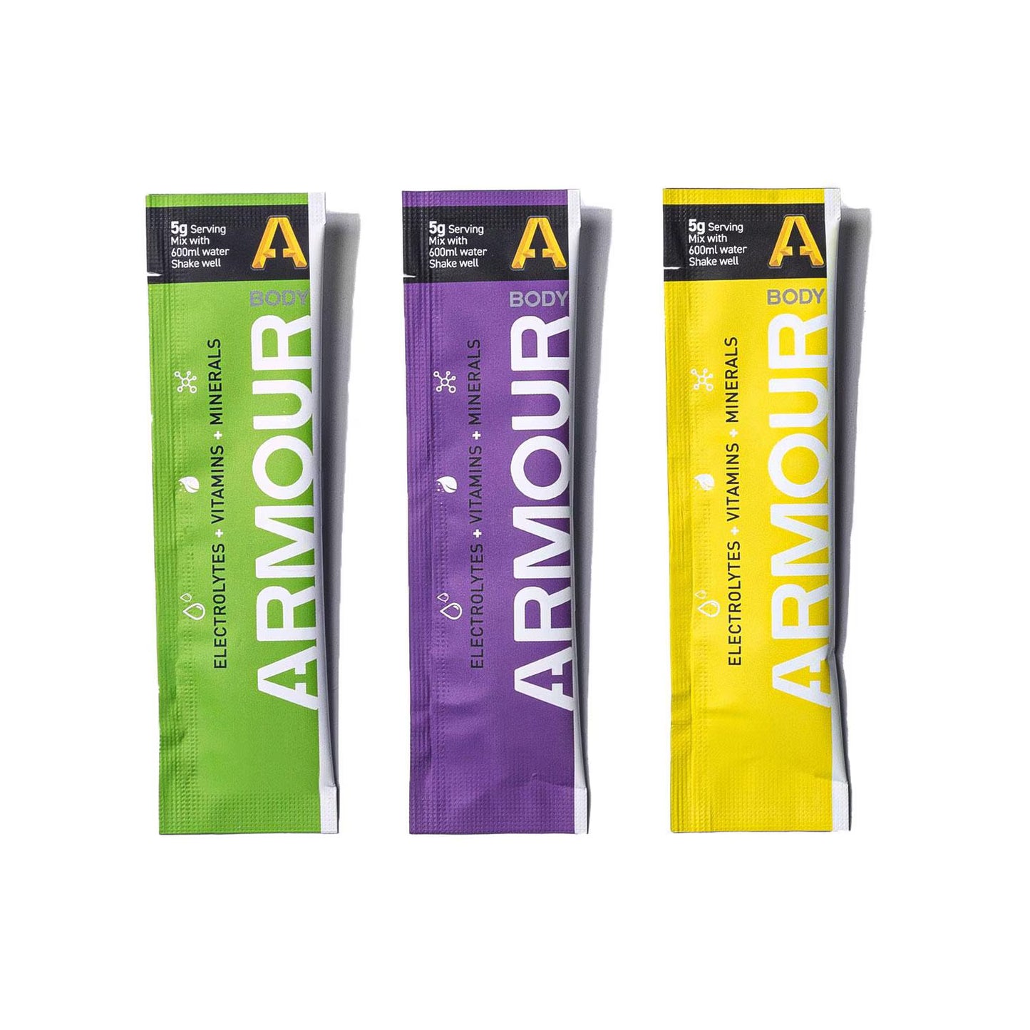 Three Armour Body electrolytes and vitamins packets in green, purple, and yellow on a white background.