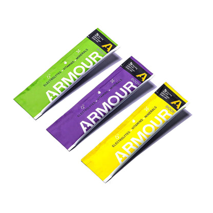Three Armour packets in green, purple, and yellow on a white background